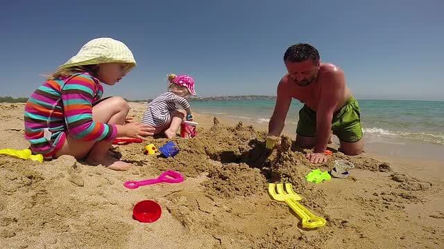 Man and two kids on the beach